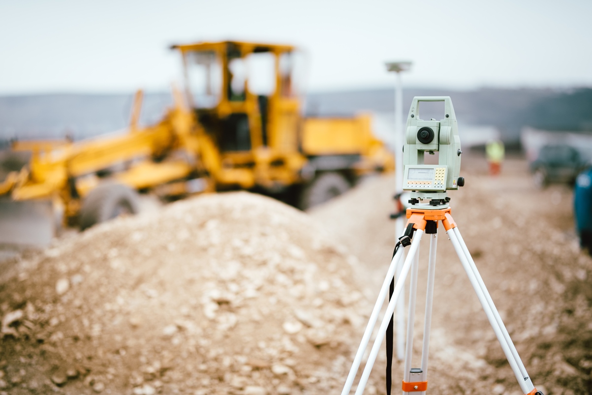 Engineer checking levels and drawings on London construction project