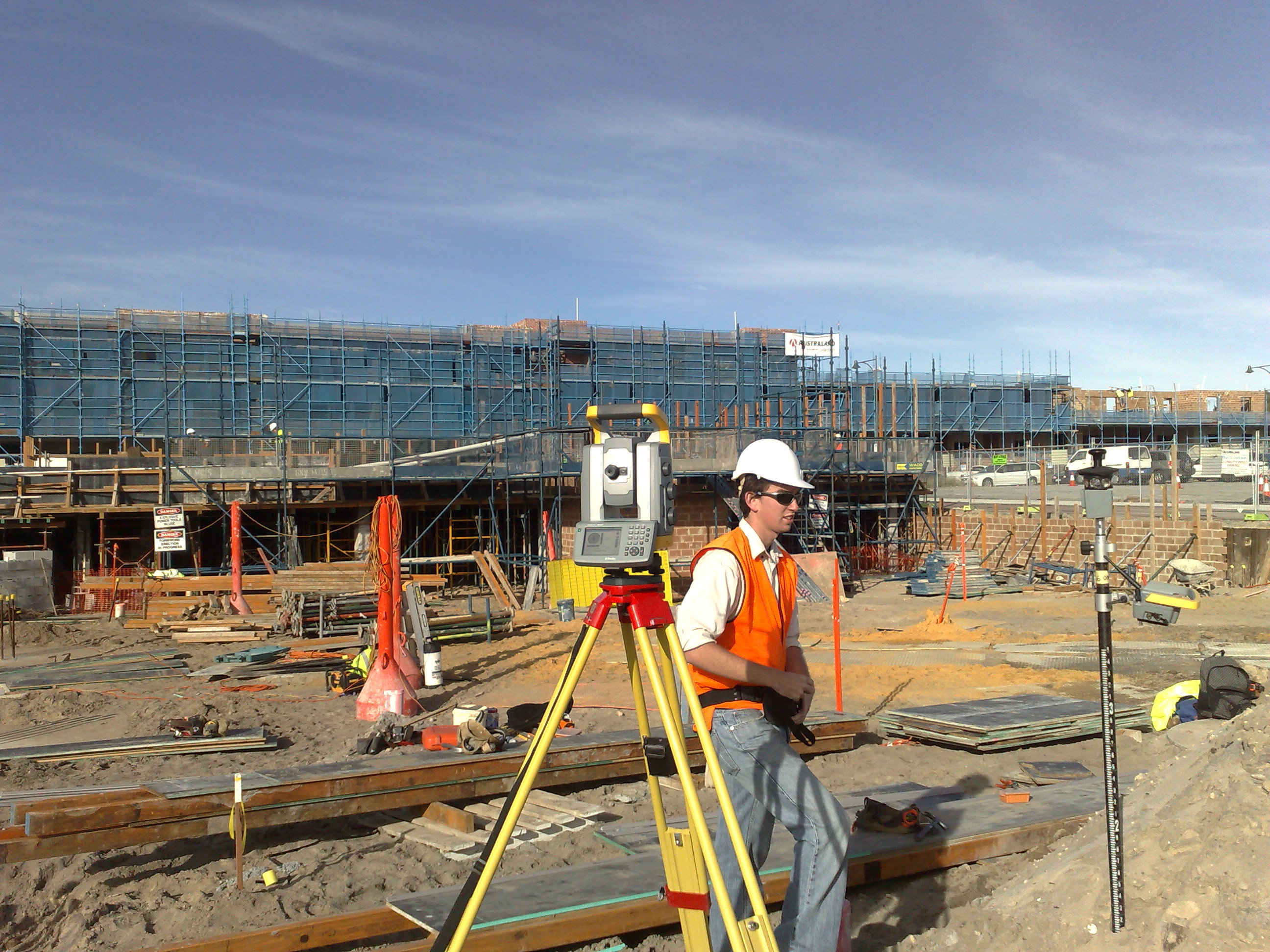 Engineer using total station with safety PPE on London site